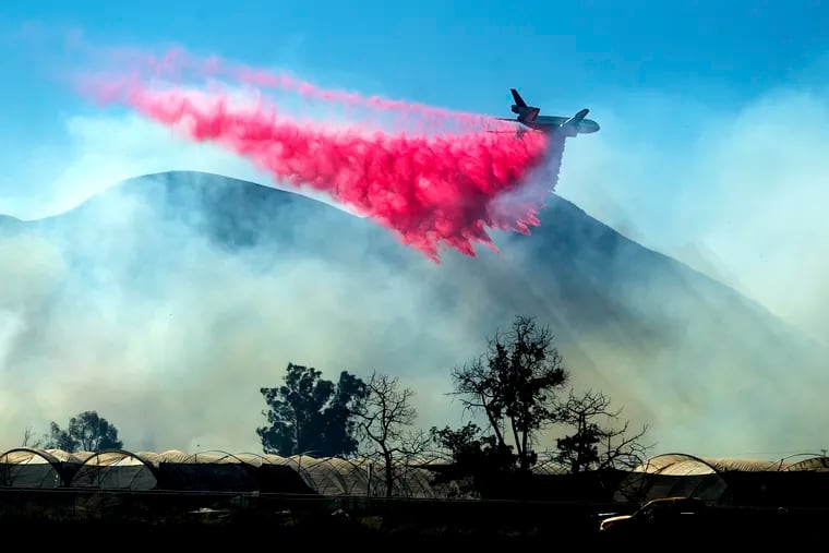 An air tanker drops retardant as the Maria Fire approaches Santa Paula, Calif., on Friday, Nov. 1, 2019. According to Ventura County Fire Department, the blaze has scorched more than 8,000 acres and destroyed at least two structures.