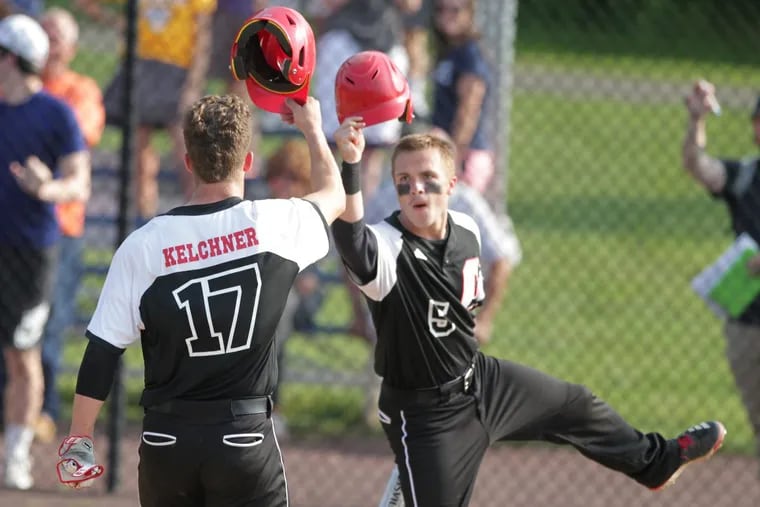 Jake Kelchner (left) and Cole Chesnet of Archbishop Carroll celebrate after Kelchner hit a two-run home run against Cardinal OHara.