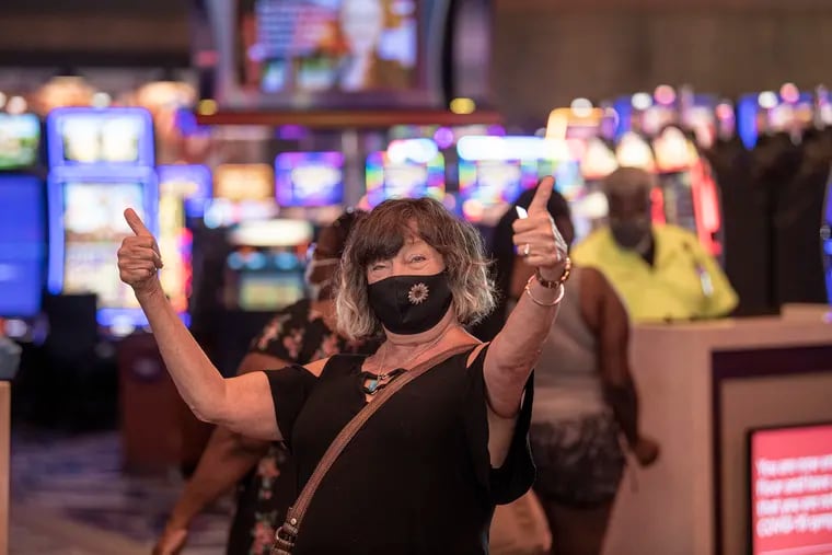 Mary Collins, of Prospect Park, gives the thumbs up as she enters the Harrah's Philadelphia Casino and Racetrack during reopening day in Chester, PA. Friday, June 26, 2020.