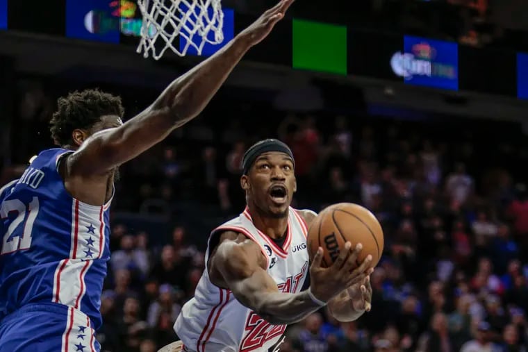 Sixers center Joel Embiid tries to block the Heat’s Jimmy Butler at the Wells Fargo Center in February 2023.