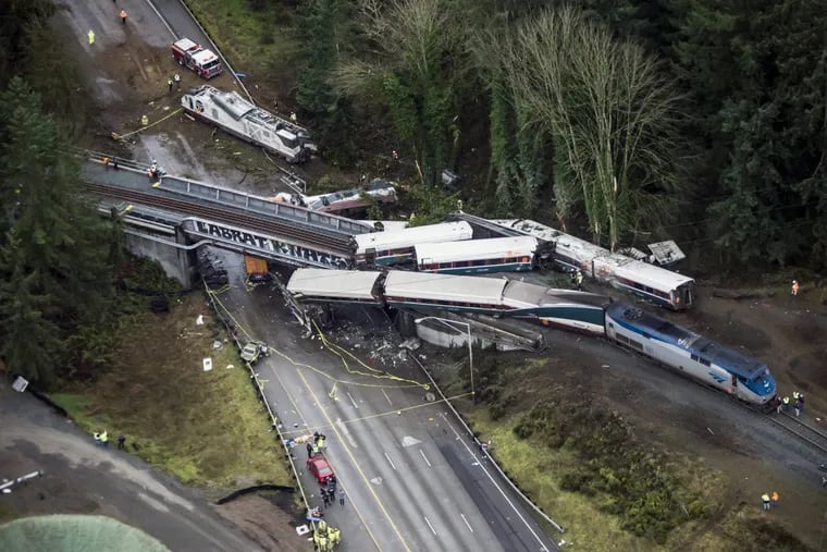 Cars from an Amtrak train that derailed lie spilled onto Interstate 5, Monday, Dec. 18, 2017, in DuPont, Wash. The Amtrak train making the first-ever run along a faster new route hurtled off the overpass Monday near Tacoma and spilled some of its cars onto the highway below, killing several people, authorities said. (Bettina Hansen/The Seattle Times via AP)