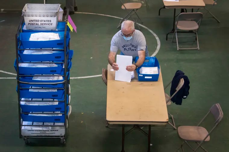 A worker counts Chester County mail ballots in the 2020 election.
