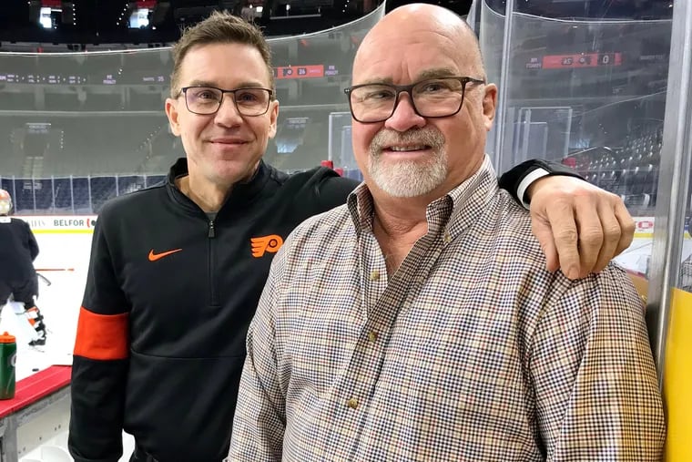Derek Settlemyre (left) and his dad, Dave, during a recent get-together at the Wells Fargo Center.
