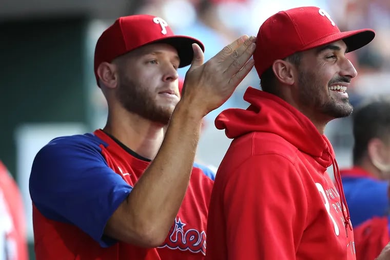 Zack Wheeler, left, of the Phillies clowns around with the hat of teammate Zach Eflin before their game against the Marlins on June 29, 2021.