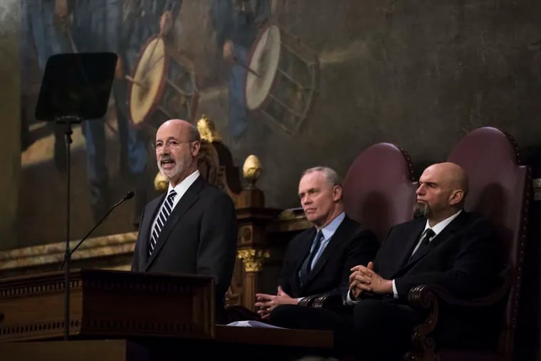 Gov. Tom Wolf (left) delivers his budget address to a joint session of the Pennsylvania House and Senate on Tuesday. House Speaker Mike Turzai, R-Allegheny, is at the center, and Lt. Gov. John Fetterman is at the right.
