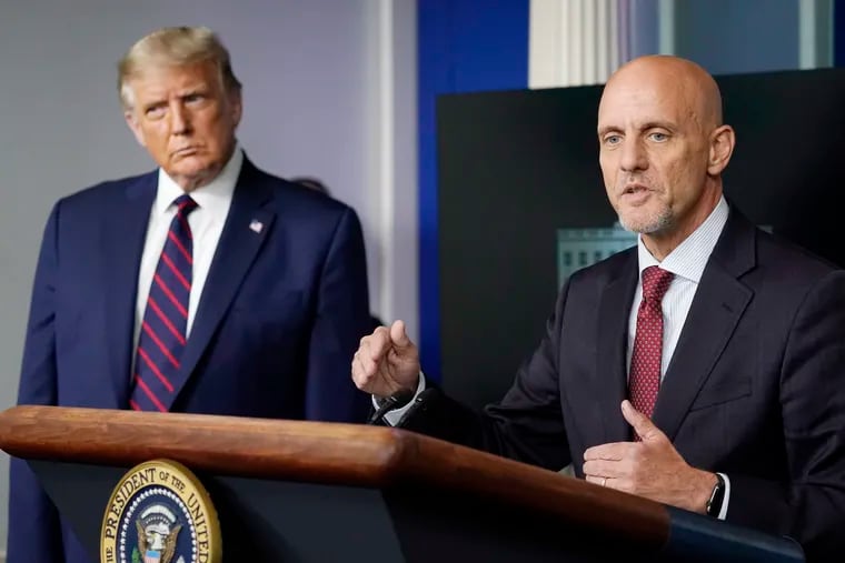 President Donald Trump listens as Dr. Stephen Hahn, commissioner of the U.S. Food and Drug Administration, speaks during a media briefing in the James Brady Briefing Room of the White House on Sunday.