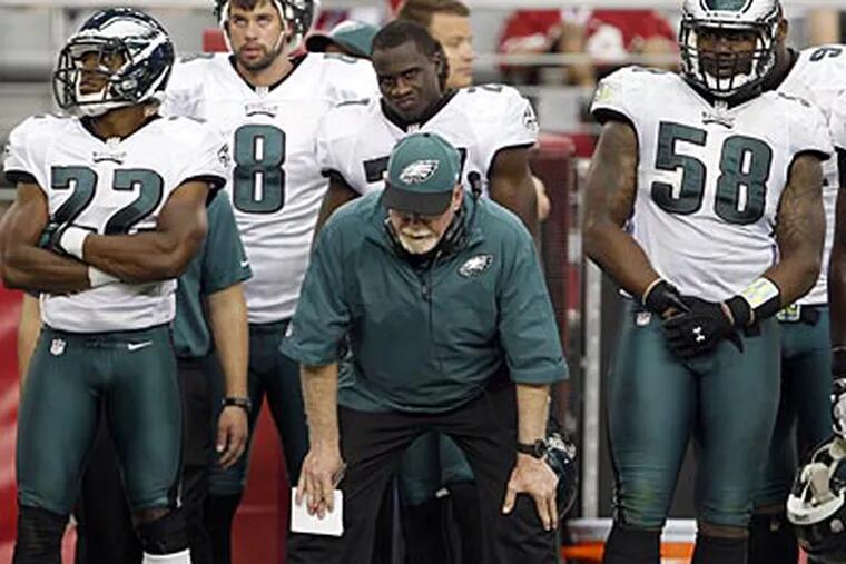 Jim Washburn and several Eagles players stand dejected during the loss to the Cardinals. (Yong Kim/Staff Photographer)
