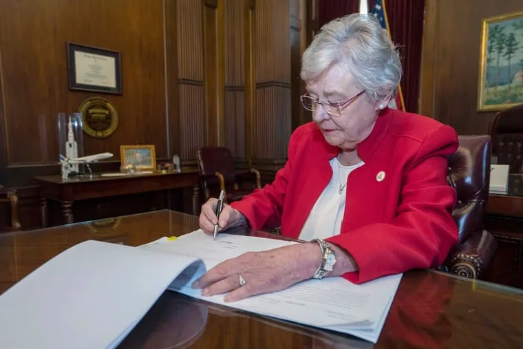 This photograph released by the state shows Alabama Gov. Kay Ivey signing a bill that virtually outlaws abortion in the state on Wednesday, May 15, 2019, in Montgomery, Ala. Republicans who support the measure hope challenges to the law will be used by conservative justices on the U.S. Supreme Court to overturn the Roe v. Wade decision which legalized abortion nationwide.