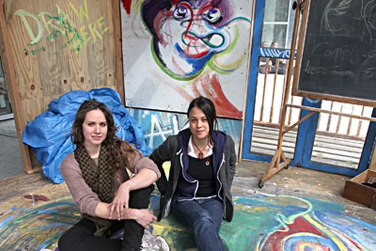 The Alternative Knowledge Access structure, outside the Tyler School of Art, has served as a free-form forum. It was created by Amy Borch (left) and Elisa Mosley. CHARLES FOX / Staff