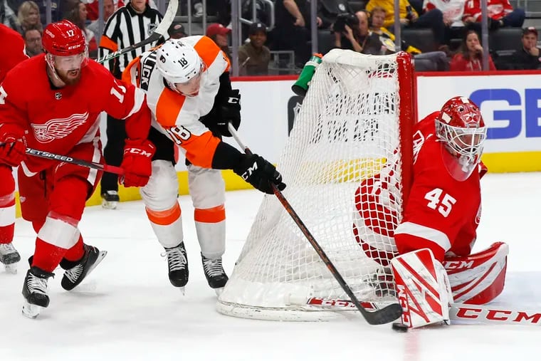 Red Wings goaltender Jonathan Bernier stops the Flyers' Tyler Pitlick (center) in a game on Feb. 3, 2020. He is among the goaltenders the Flyers can pursue.