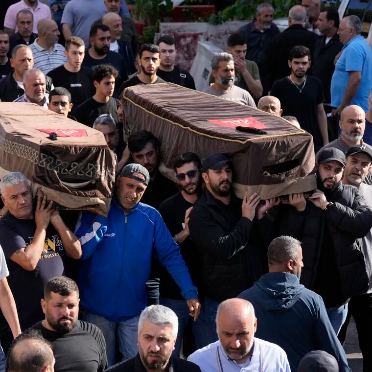 Mourners carry the coffins of two victims who were among four civilians from the same family killed on Sunday by Israeli strikes on the southern town of Mays al-Jabal, during their funeral procession on Monday, May 6, 2024.