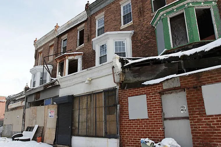 A row of dilapidated buildings sits along the 5100 block of Baltimore Avenue. (DAVID MAIALETTI / STAFF PHOTOGRAPHER)