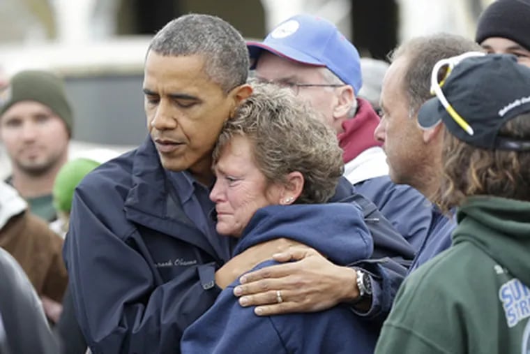 President Barack Obama, left, embraces Donna Vanzant, right, during a tour of a neighborhood affected by Hurricane Sandy on Wednesday in Brigantine, N.J. (AP Photo/Pablo Martinez Monsivais)