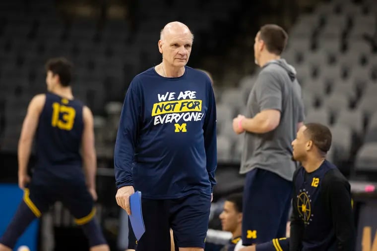Associate Head Coach Phil Martelli of Michigan walks out on the court before they practice for Villanova game.