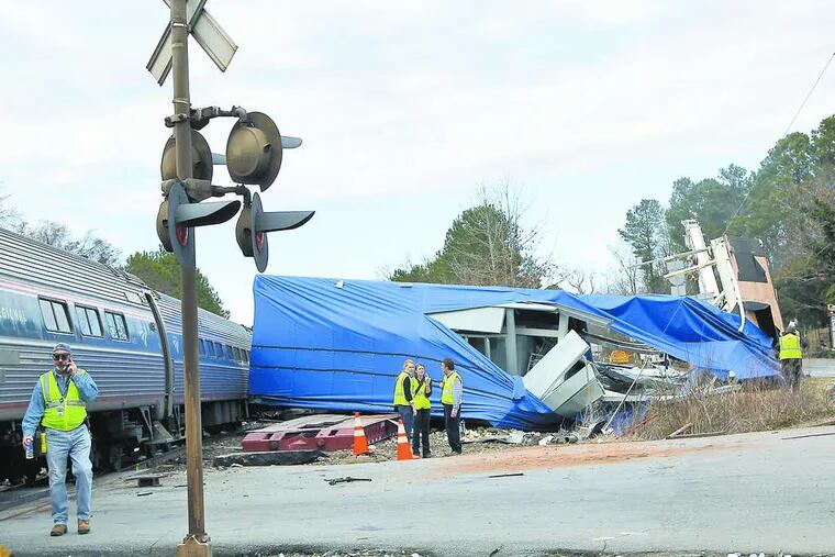 The driver of an oversize load that was struck by an Amtrak train is a convicted felon who nonetheless has a valid commercial driver's license.