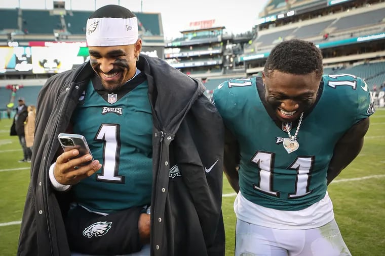 Eagles quarterback Jalen Hurts (1)  and receiver A.J. Brown  after a victory over the Titans at Lincoln Financial Field on  Dec. 4.