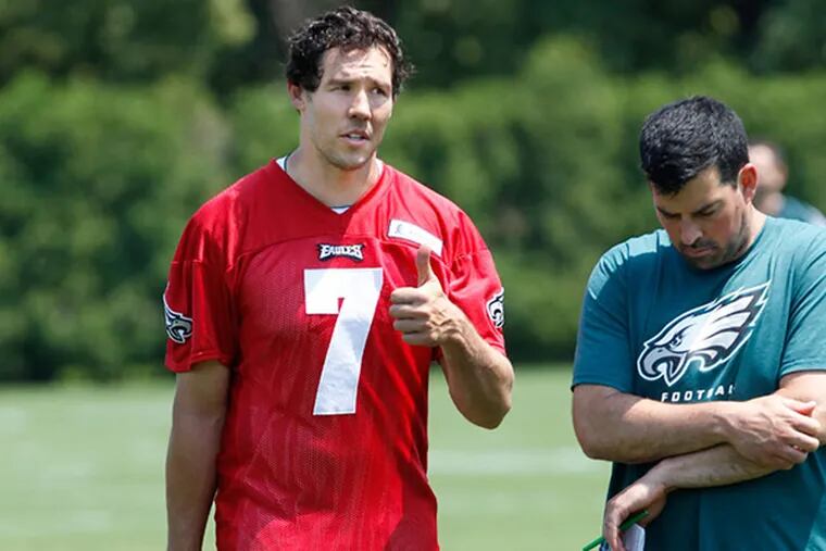 Eagles quarterback Sam Bradford, #7, left, gives a thumbs up sign to Eagles personel on the sidelines after Monday's practice. Eagles practice at the NovaCare Center. (Michael Bryant/Staff Photographer)