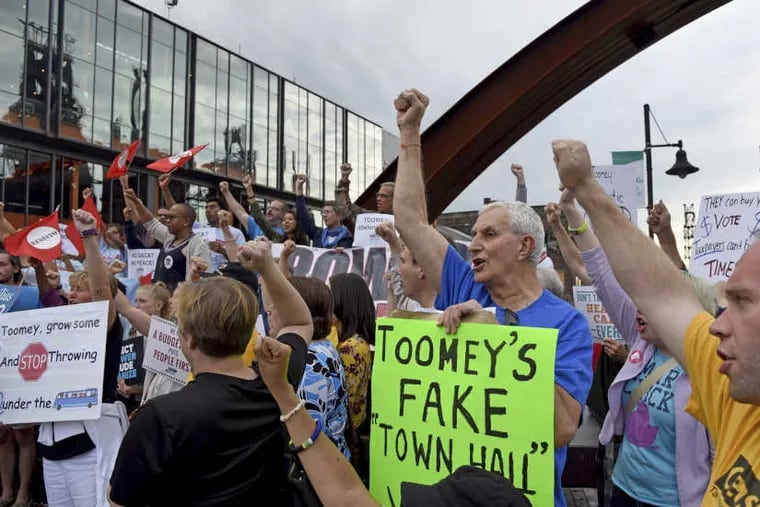 John Paul Marosy (center) of Bethlehem joins protesters outside the studios of PBS-39 as Sen. Pat Toomey holds a town-hall meeting in Bethlehem August 31, 2017, after months of public pressure from liberal opponents of President Trump that the senator has been hiding from his constituents. Attendance was limited to 54 people.