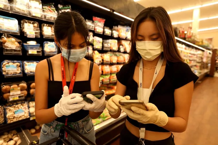 Christine Riel, 16, left, and Krysta Mendoza, 17, juniors at West Ranch High School in Santa Clarita, Calif., are volunteers with Six Feet Supplies, a free service started by local teenagers to help the most vulnerable during the coronavirus outbreak.