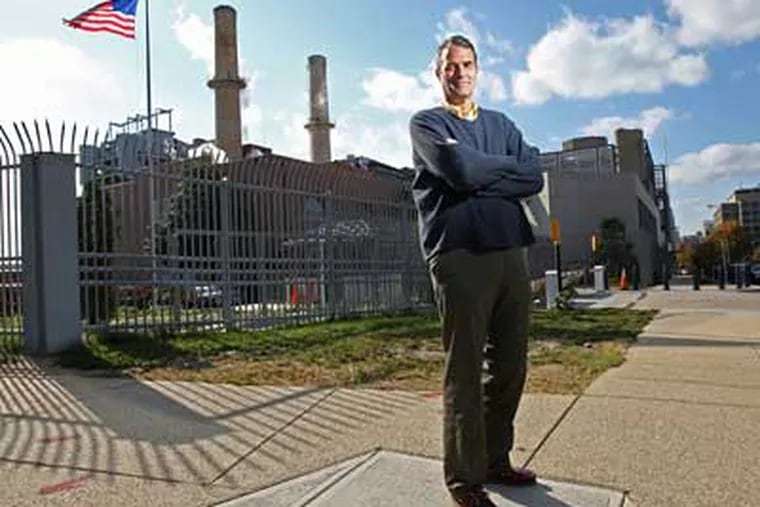 Jim Pew stands in front of the only coal-fired power plant that operates inside the city limits of Washington D.C. Pew is a staff attorney in Earthjustice's Washington, D.C. office. (Michael Bryant/Inquirer)