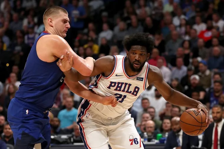 Nikola Jokic (left), according to the NBA, fouled Joel Embiid in the final second of their game in Denver on Friday, a 100-97 Sixers loss.