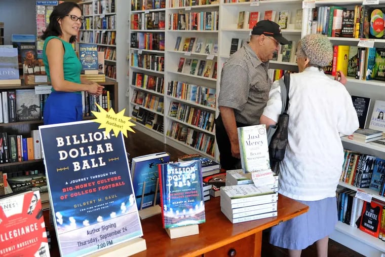 Julie Beddingfield (left), the owner of Inkwood Books on Kings Highway in Haddonfield, talks with customers in 2015. Her store moved to larger quarters across the street last year, amid a particularly challenging period for booksellers.