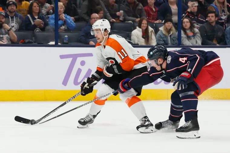 Travis Konecny (11) looks for an open shot as Columbus Blue Jackets' Vladislav Gavrikov defends. Konecny is out against Montreal with an upper-body injury.