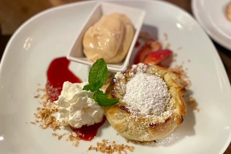 The apple dumpling is house made and served with salted caramel cremeux at Village Vine in Swarthmore.
