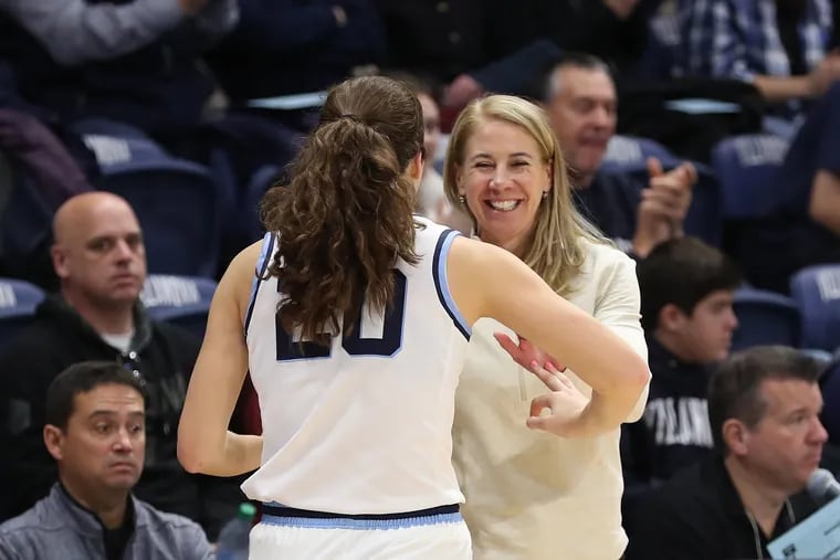 Maddy Siegrist (left) and coach Denise Dillon celebrate a recent win. On Wednesday, the two celebrated a win over La Salle which wrapped up the Big 5 title for the Wildcats, their eighth straight.
