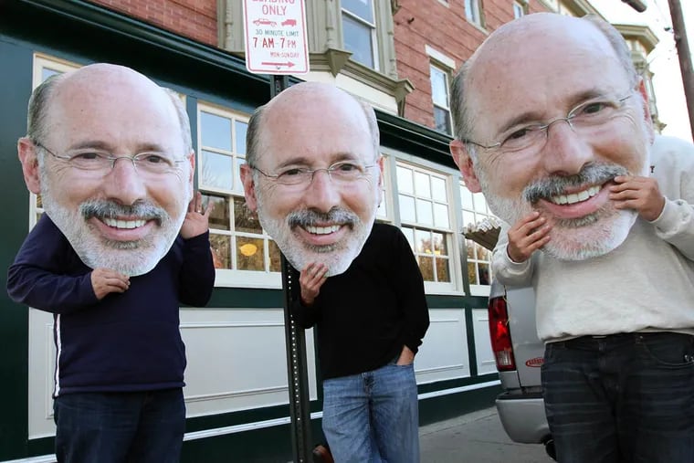 IBEW Local 98 members hold up large photos of Tom Wolf's face outside Famous 4th Street Deli in Philadelphia on Election Day on November 4, 2014. ( DAVID MAIALETTI / Staff Photographer )