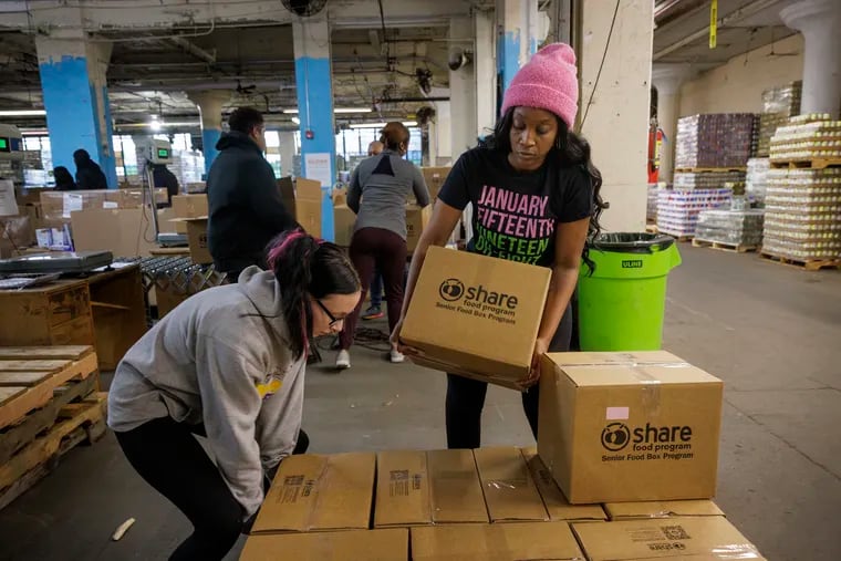 At left is Kaylor Haug, intern/volunteer and CJ Cross-Johnson, volunteer loading boxes of food for Senior Food Box Program. Share Food Program in Hunting Park is among the largest DoorDash operations in the world.