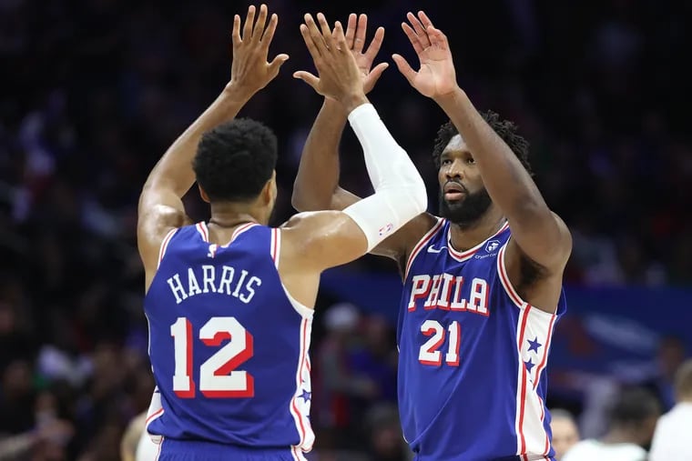 Tobias Harris (left) is congratulated by teammate Joel Embiid after Harris made a 3-pointer against the Celtics on Nov. 8.