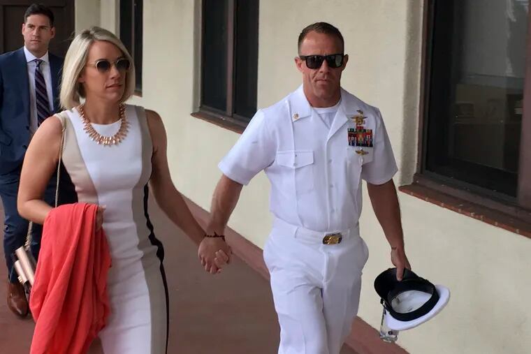 Navy Special Operations Chief Edward Gallagher, right, walks with his wife, Andrea Gallagher as they arrive to military court on Naval Base San Diego, Tuesday, June 18, 2019, in San Diego. Jury selection continued Tuesday morning in the court-martial of the decorated Navy SEAL, who is accused of stabbing to death a wounded teenage Islamic State prisoner and wounding two civilians in Iraq in 2017. He has pleaded not guilty to murder and attempted murder, charges that carry a potential life sentence. (AP Photo/Julie Watson)