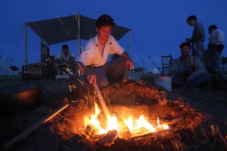 Matthew Flood builds a camp fire July 5, 2013.