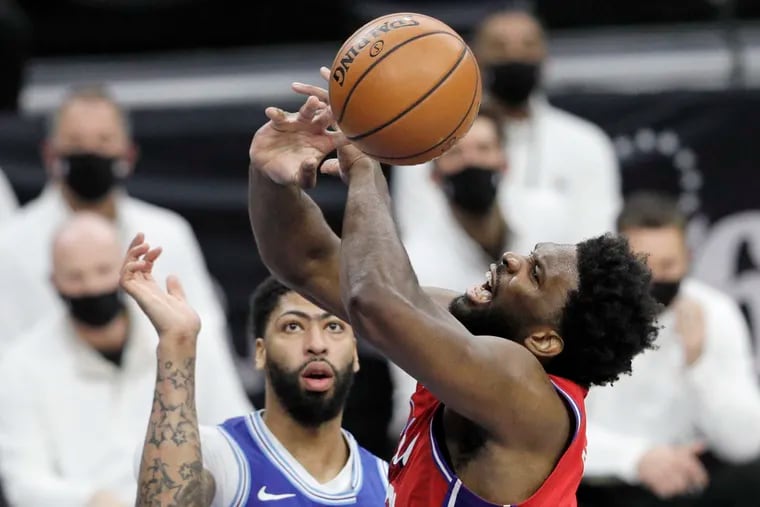 The Lakers' Anthony Davis looked on as the Sixers' Joel Embiid lost the ball after being fouled in the first half on Wednesday.