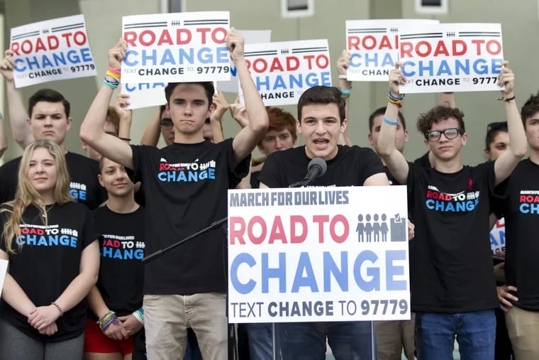 Cameron Kasky, center, speaks during a news conference, Monday, June 4, 2018, in Parkland, Fla. A day after graduating from high school, a group of Florida school shooting survivors has announced a multistate bus tour to "get young people educated, registered and motivated to vote." (AP Photo/Wilfredo Lee)