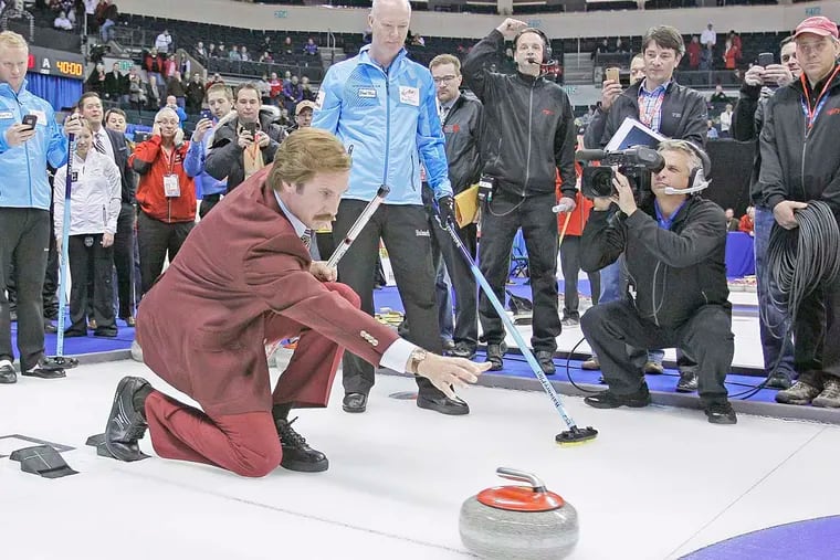 Will Ferrell as "Ron Burgundy" releases a rock as Glenn Howard and his team look on after the opening ceremonies at the 2013 Roar Of The Rings championship in Winnipeg.