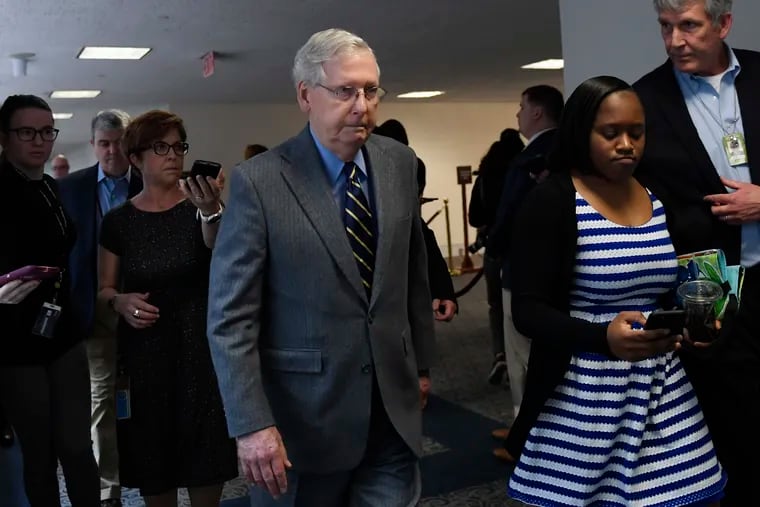 Senate Majority Leader Mitch McConnell leaves a meeting on Capitol Hill Friday to work on an economic package to deal with the coronavirus.