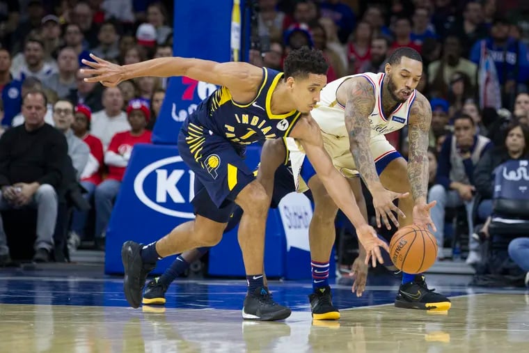 Malcolm Brogdon, left, of the Indiana Pacers steals the ball from Mike Scott of the Sixers during the 3rd quarter at the Wells Fargo Center on Nov. 30, 2019.
