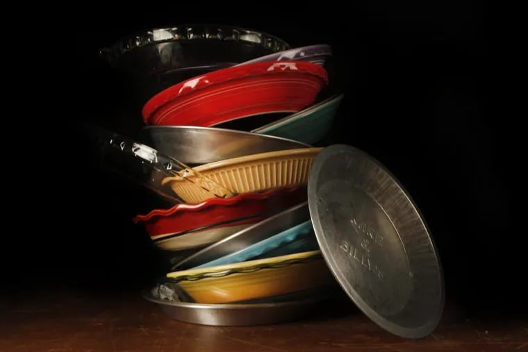 A collection of metal, glass and ceramic pie dishes.