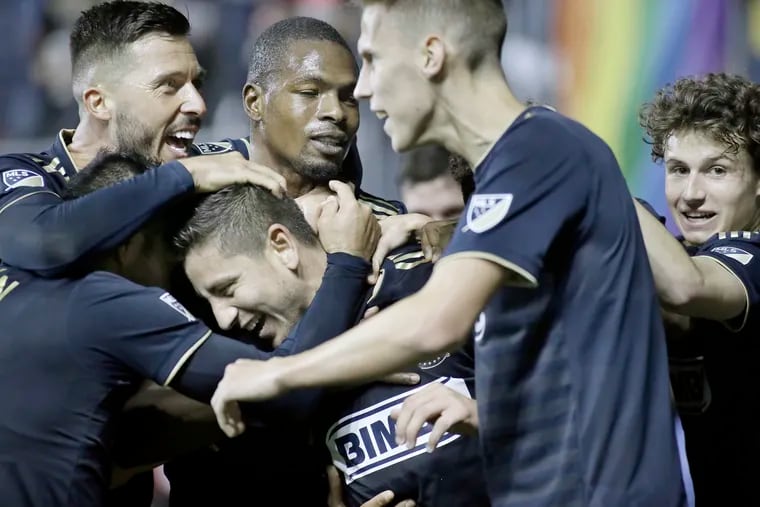 Alejandro Bedoya is surrounded by happy teammates after scoring the winning goal in the Union's 2-1 victory over FC Dallas at Talen Energy Stadium.