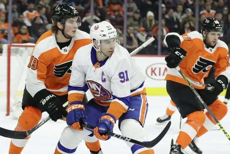 Flyers center Nolan Patrick defends New York Islanders center John Tavares in a game last season. Tavares is the top player on the free-agent market.