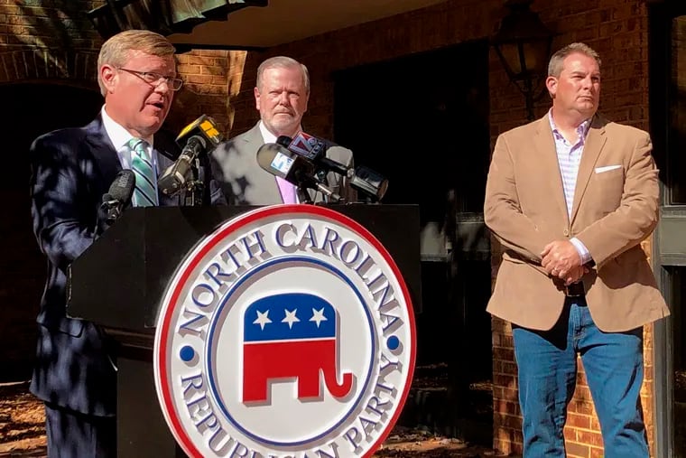 North Carolina House Speaker Tim Moore (left) appears with state Senate leader Phil Berger and state House Majority Leader John Bell at a news conference in November 2020. Moore is at the center of a voting rights case to be heard Wednesday by the U.S. Supreme Court.
