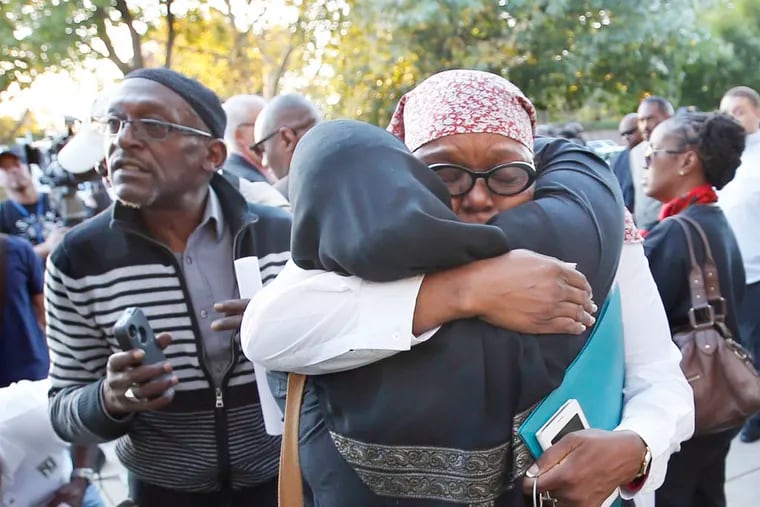 File photo: Majeedah Rashid (right) of the Nicetown CDC Community Center hugs a vigil attendee in September after the death of Aisha Abdur-Rhaman. ( YONG KIM / STAFF PHOTOGRAPHER )