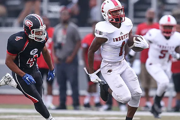 Gratz's Javon Whitfield can't stop Imhotep's Tyliek Raynor on his 58 yard TD run on the first play during the 1st  quarter Friday night in North Philadelphia, September 4, 2015.