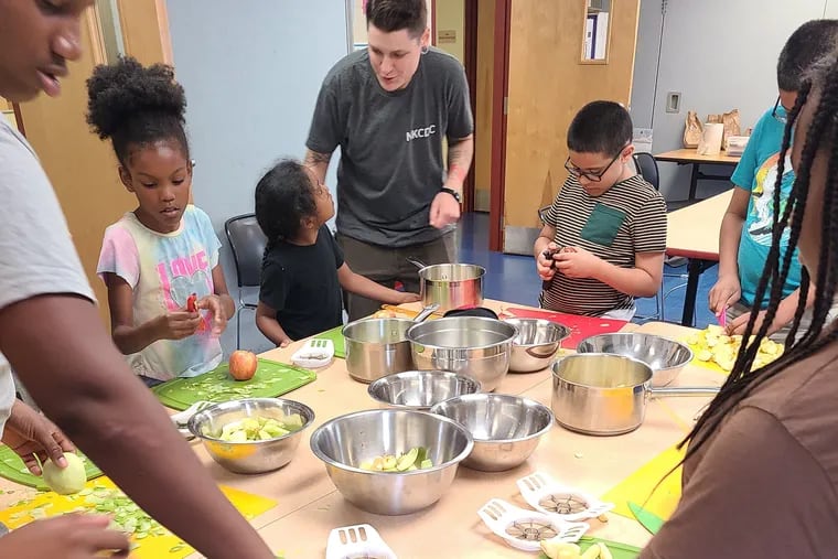 The New Kensington Community Development Corp.'s Nourish program teaches Kensington kids how to make applesauce and scrambled eggs at a recent youth cooking workshop at the McPherson Library. Nourish will partner with PB&J to help its teenagers cook for one another.