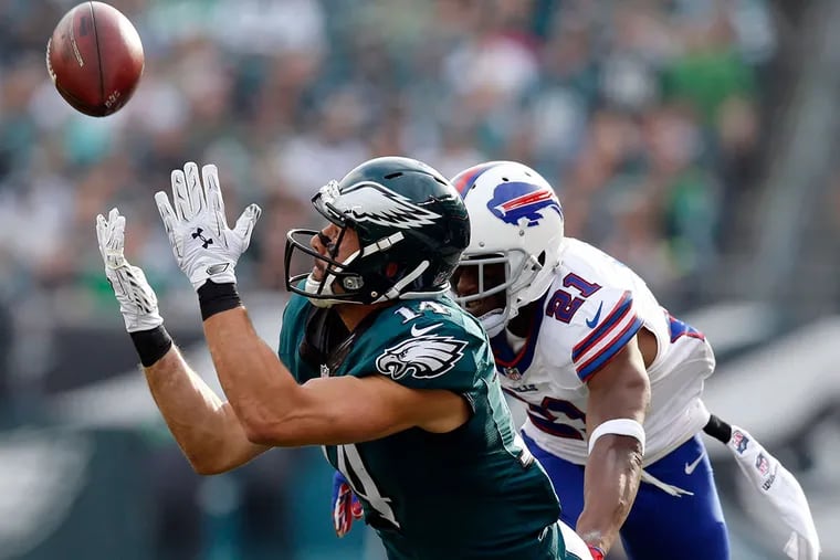 Eagles' Riley Cooper fails to catch the football while defended by the Bills' Leodis McKelvin Sunday, December 13, 2015 in Philadelphia. YONG KIM / Staff Photographer