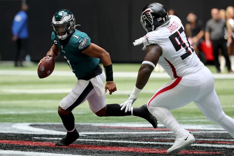 Philadelphia Eagles quarterback Jalen Hurts scrambles away from Atlanta Falcons defensive tackle Grady Jarrett in the second quarter. Hurts and the Eagles committed zero turnovers in the 32-6 blowout of Atlanta, the biggest reason the Eagles won.