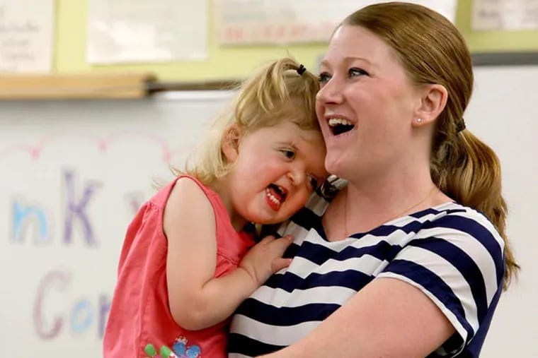 Kerry Lynch holds her daughter, Mary Cate Lynch, 2, at Oriole Park Elementary School in Chicago on June 13, 2014, to give a disability awareness presentation and teach compassion, as part of a national movement inspired by the book "Wonder." (Antonio Perez/Chicago Tribune/MCT)