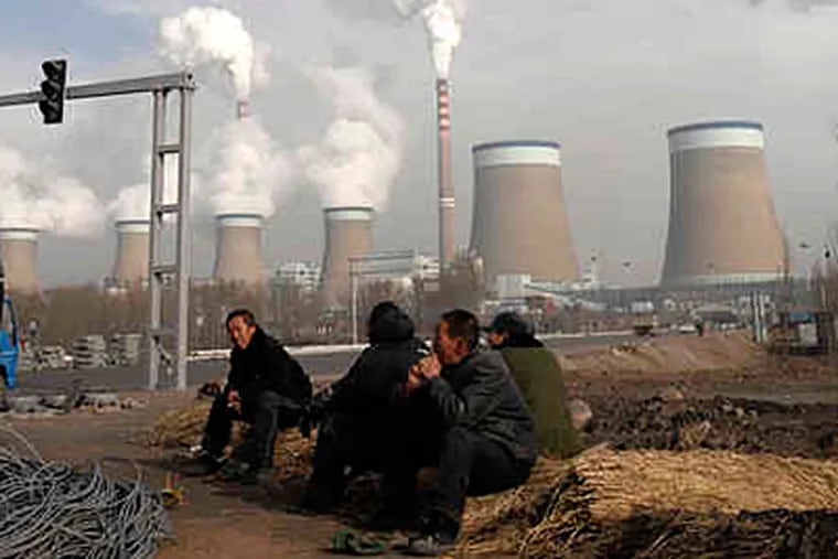 A work break at a coal-fired power plant in Shanxi province, China, on Dec. 3. It was Sweden's Arvid Hogbom who at the dawn of the 20th century first suggested that humans might alter the climate by burning coal. (Andy Wong / AP)